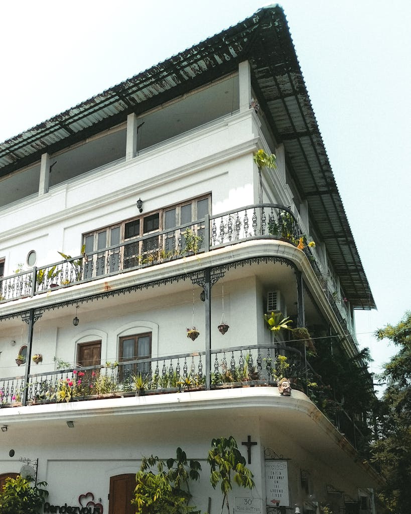 Charming colonial building with wrought iron balconies in sunny Puducherry.