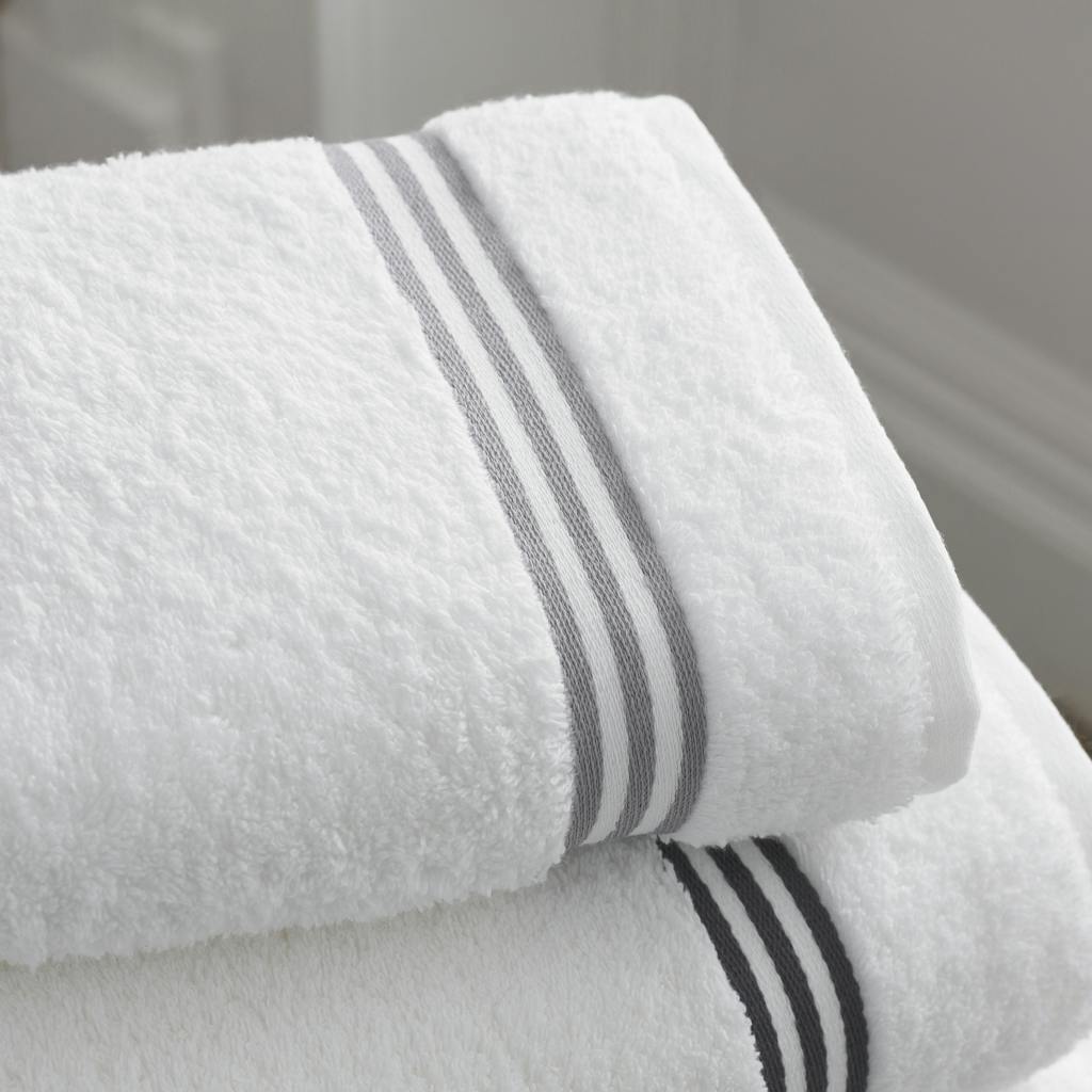 Elegant white towels with gray stripes, perfect for modern bathroom decor.